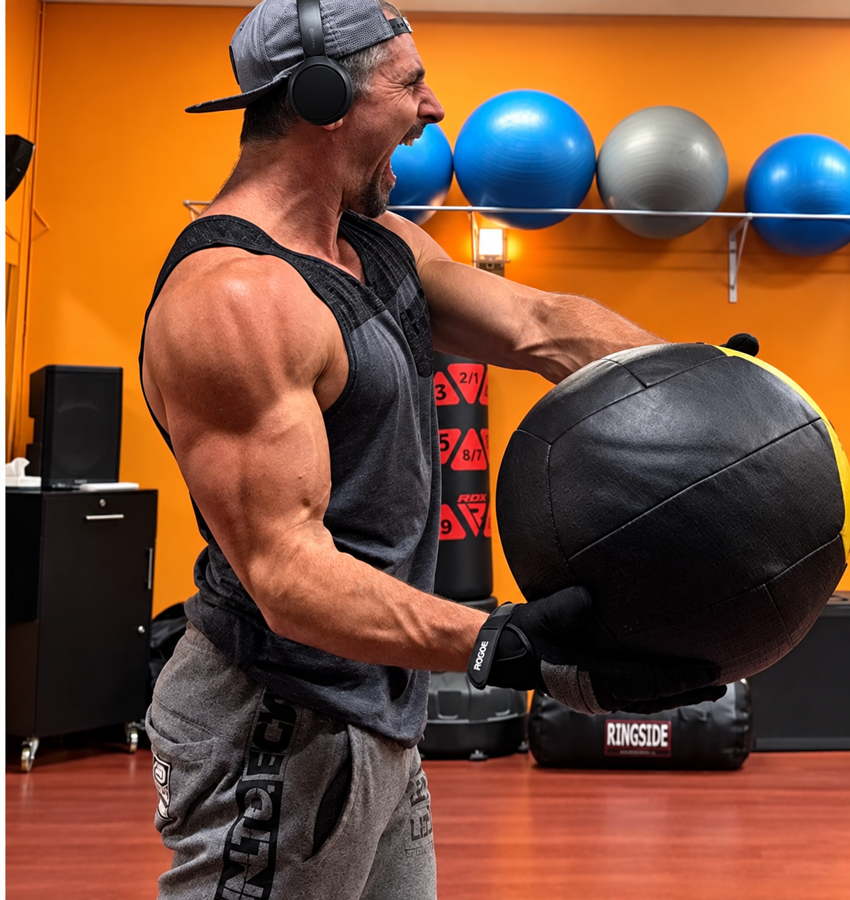 Coach Rob training with a weighted wall ball in the gym